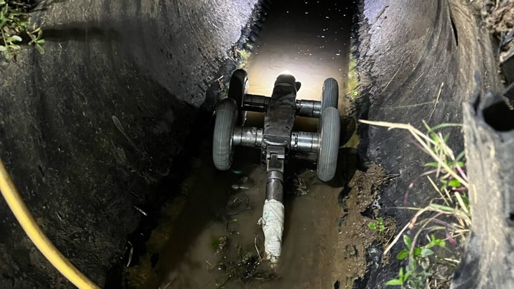 plumber using a CCTV drain camera inside a pipe system